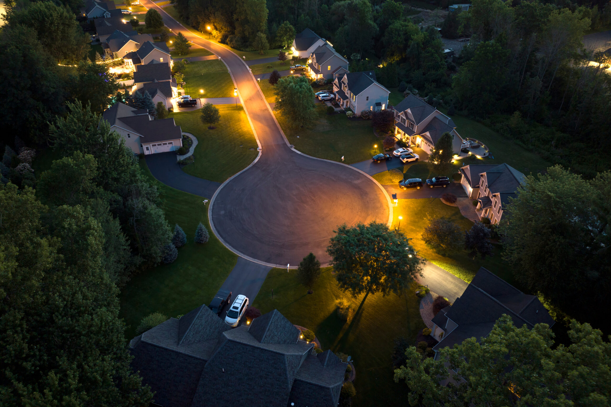 Aerial view of a residential neighborhood lit up at night