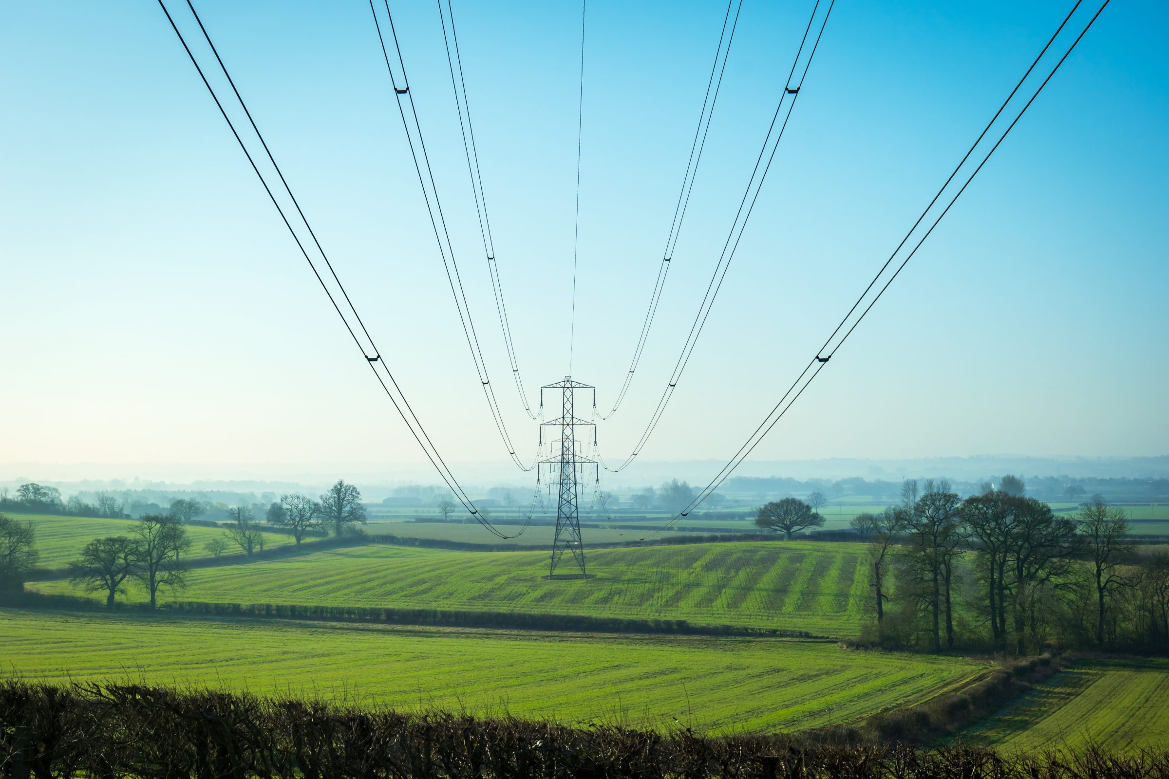 Power lines crossing open farmland